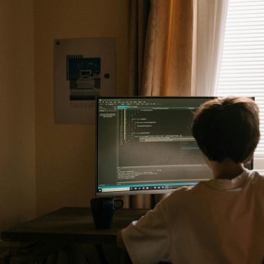 Boy in White Shirt Sitting in Front of Computer